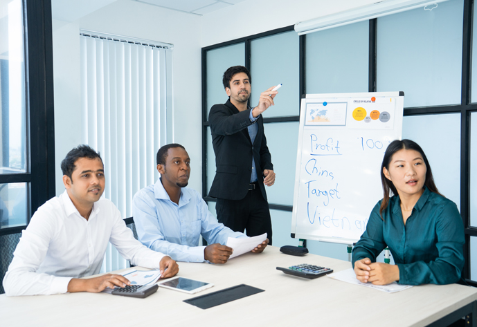Serious handsome presenter showing aside while explaining data at meeting. Confident male analyst working with audience during presentation. Strong argument concept