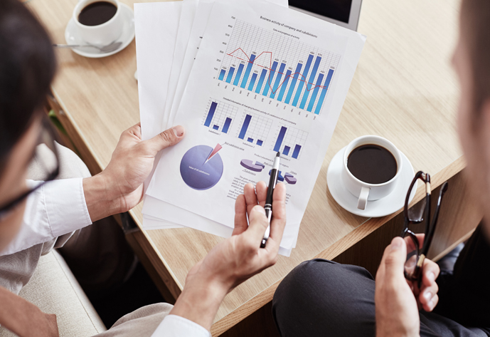 Male employee explaining financial data to colleague